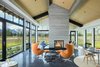 Modern home with Living Room, Chair, Coffee Tables, End Tables, Ceiling Lighting, Pendant Lighting, Recessed Lighting, Concrete Floor, Ottomans, Two-Sided Fireplace, and Gas Burning Fireplace. Great Room with expansive Tetons View Photo 6 of The Landing
