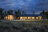 Modern home with Exterior, House Building Type, Metal Roof Material, Wood Siding Material, and Gable RoofLine. Exterior at Night Photo of The Landing