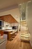 Modern home with Kitchen, Engineered Quartz Counter, White Cabinet, Medium Hardwood Floor, Ceiling Lighting, Recessed Lighting, Pendant Lighting, Refrigerator, Glass Tile Backsplashe, Wall Oven, Cooktops, Range Hood, Microwave, Dishwasher, and Drop In Sink. Kitchen Photo 8 of The Cliffhanger House