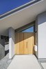 Modern home with Exterior, House Building Type, Metal Roof Material, Stucco Siding Material, Wood Siding Material, and Gable RoofLine. Entrance. Photo 5 of House in Ohue