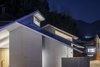 Modern home with Exterior, House Building Type, Metal Roof Material, Wood Siding Material, Stucco Siding Material, and Gable RoofLine. Night view. Photo 15 of House in Ohue