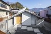 Modern home with Exterior, House Building Type, Metal Roof Material, Stucco Siding Material, Gable RoofLine, and Wood Siding Material. Facade. Thin and deep eaves. Photo 2 of House in Ohue