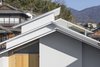 Modern home with Exterior, House Building Type, Metal Roof Material, Wood Siding Material, Stucco Siding Material, and Gable RoofLine. Eaves detail. Photo 3 of House in Ohue