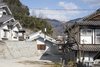 Modern home with Exterior, House Building Type, Metal Roof Material, Gable RoofLine, Stucco Siding Material, and Wood Siding Material. Facade. Harmony with the surrounding environment. Photo of House in Ohue