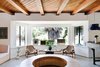 Modern home with Living Room, Sofa, Pendant Lighting, Chair, Coffee Tables, and Terrazzo Floor. The rooms were designed to echo the region’s bungalow-style homes with simple midcentury elements. Each of the 13 rooms feature exposed white wood beams and offer private patios with handmade hammocks. Bed frames by Design Within Reach host Casper mattresses where guests can rest their heads after a long day of surf and sun. Photo 4 of Native Hotel