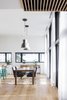 Modern home with Dining Room, Table, Stools, Chair, Ceiling Lighting, Pendant Lighting, and Light Hardwood Floor. dining room, 10 feet wall, large windows Photo 5 of Résidence à Stoneham