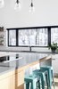 Modern home with Kitchen, Stone Counter, Cooktops, Wood Counter, Light Hardwood Floor, Pendant Lighting, White Cabinet, and Drop In Sink. banner window, black trim Photo 6 of Résidence à Stoneham