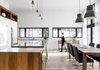 Modern home with Kitchen, Light Hardwood Floor, Cooktops, Wood Cabinet, Refrigerator, Drop In Sink, Pendant Lighting, Wood Counter, White Cabinet, and Wine Cooler. kitchen/dining area Photo of Résidence à Stoneham
