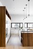 Modern home with Kitchen, White Cabinet, Cooktops, Refrigerator, Wood Counter, Ceiling Lighting, Light Hardwood Floor, Wood Cabinet, Microwave, Pendant Lighting, Drop In Sink, and Wall Oven. white/wood kitchen Photo 4 of Résidence à Stoneham