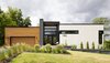 Modern home with Exterior, Stone Siding Material, Wood Siding Material, Metal Roof Material, Flat RoofLine, and House Building Type. Front facade. Photo of Résidence à Stoneham