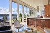 Modern home with Living Room, Coffee Tables, Chair, Ceiling Lighting, Accent Lighting, Pendant Lighting, and Light Hardwood Floor. Brooks Kitchen and Deck Photo of Brooks Remodel