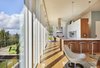 Modern home with Kitchen, Engineered Quartz Counter, White Cabinet, Wood Cabinet, Light Hardwood Floor, Glass Tile Backsplashe, Ceiling Lighting, Pendant Lighting, Refrigerator, Wall Oven, and Undermount Sink. Brooks Kitchen & Deck Photo 5 of Brooks Remodel
