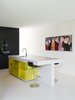 Modern home with Kitchen, Microwave, Wall Oven, Stone Counter, Colorful Cabinet, Undermount Sink, and Recessed Lighting. At a home in Monterrey, Nuevo León, Mexico that was designed as a collaboration between Gilberto L. Rodríguez, of GLR Arquitectos, and Alberto Campo Baeza, of Estudio Campo Baeza, the architects sought to pay homage to Mexican architect Luis Barragán. A strong presence of light and color are at play throughout the house, including the kitchen, where a clean white kitchen island covers bright neon yellow storage. The cabinets are translucent, seeming to glow from within, and provide a focal point in the otherwise white and black kitchen. Photo 7 of Villa X