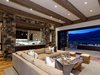Modern home with Living Room, Sectional, Coffee Tables, Recessed Lighting, Two-Sided Fireplace, and Gas Burning Fireplace. Living room with natural stone and wood beam elements adorned with Ralph Lauren furnishings opens to this Aspen outdoor oasis Photo 6 of Aspen Vision House