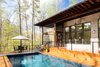Modern home with Outdoor, Back Yard, Hardscapes, Large Pools, Tubs, Shower, Swimming Pools, Tubs, Shower, Lap Pools, Tubs, Shower, Small Patio, Porch, Deck, Wood Patio, Porch, Deck, Metal Fences, Wall, Wire Fences, Wall, Hanging Lighting, and Landscape Lighting. The back of the house has a covered deck, a screen porch and a pool for entertaining. Photo 9 of Professor's House