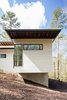 Modern home with Exterior, House, Green Roof Material, Concrete Siding Material, Metal Siding Material, and Flat RoofLine. Parts of the house flow over the land to allow the existing hydrology of the site to be unimpeded. Photo 6 of Professor's House