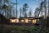 Modern home with Exterior, House, Green Roof Material, Concrete Siding Material, Metal Siding Material, and Flat RoofLine. The Professor's house is a hub for her neighbors to come visit and use her pool. At night the house is designed to glow like a lantern, welcoming them to visit. Photo of Professor's House