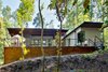 Modern home with Exterior, House, Green Roof Material, Concrete Siding Material, Metal Siding Material, and Flat RoofLine. The back of the house nestles into the woods. Photo 2 of Professor's House