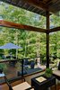 Modern home with Outdoor, Small Patio, Porch, Deck, Wood Patio, Porch, Deck, Metal Patio, Porch, Deck, Decking Patio, Porch, Deck, Metal Fences, Wall, Wire Fences, Wall, Hanging Lighting, Side Yard, Trees, and Hardscapes. An extra tall ceiling in the screen porch is to catch the breezes and help keep the porch cool in the hot NC climate. Photo 7 of Professor's House