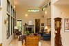 Modern home with Living Room, Chair, Sofa, Ottomans, End Tables, Coffee Tables, Console Tables, Wall Lighting, Medium Hardwood Floor, and Two-Sided Fireplace. View to the living room from the dining room. Photo 16 of Professor's House