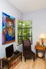 The corner window in the Master Bedroom provides a reading nook with abundant natural light. The painting on the wall is a portrait of the Professor's dog, Calamity Jane. Photo 18 of Professor's House modern home
