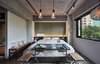 Modern home with Bedroom, Pendant Lighting, Bed, Bench, Track Lighting, Concrete Floor, Night Stands, and Accent Lighting. Located on the fifth floor of an unassuming building in Datong district, Play Design Hotel is a hidden gem with only a small sign to announce its presence. Polished concrete walls and floors coupled with large, black, metal-framed windows create an elegant backdrop for the hand-picked design objects sourced from over 100 local Taiwanese designers. Photo 2 of Play Design Hotel