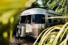 Modern home with Exterior, Airstream Building Type, Metal Siding Material, and Metal Roof Material. Located in Eastern Ojai, Caravan Outpost enjoys close proximity to downtown, yet its oasis-like enclosure of palm trees and lush landscaping makes you feel a world away. Photo of Airstream Caravan Outpost