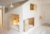 Modern home with Bedroom, Pendant Lighting, Bed, Wall Lighting, and Light Hardwood Floor. Following the house-within-a-house concept, this playful playhouse-like addition features an all-plywood interior. Photo of Michelberger Hotel