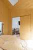 Modern home with Bedroom, Bed, Light Hardwood Floor, and Wall Lighting. There is also a staircase that leads to a second bedroom and hammock/sitting area. The slight changes in elevation help to create added visual interest within the suite.
To round out the house-like appearance, Larsen refers to the space around the wooden volume as the "outside garden," which is complete with a rain shower and step-down tub. Photo 5 of Michelberger Hotel