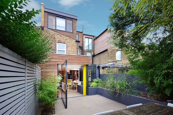 A large pivot door helps create a smooth indoor/outdoor connection.

