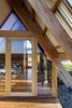 Modern home with Exterior, Cabin Building Type, Metal Roof Material, A-Frame RoofLine, and Wood Siding Material. The glazed door and other openings allow guests to enjoy sunset views from bed. Photo 8 of Kimo Estate