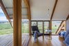 Modern home with Bedroom, Chair, Medium Hardwood Floor, Bed, Pendant Lighting, and Night Stands. Sustainably sourced Australian hardwoods are used throughout the tiny dwelling, while handcrafted details evoke the character of the surrounding agricultural buildings. Photo 4 of Kimo Estate