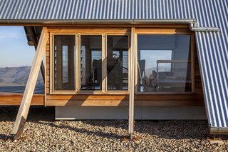 The A-frame structure is elevated on pad footings. 