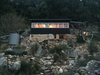 Modern home with Exterior, House Building Type, and Wood Siding Material. Rainwater is harvested for bathing and washing, while greywater is reused for irrigating the garden. Photo 4 of The Little Black Shack