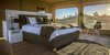Modern home with Bedroom, Medium Hardwood Floor, Night Stands, Chair, Bed, Table Lighting, Lamps, Floor Lighting, and Rug Floor. The 581-square-foot Uralla, which means ‘home on the hill’, is the new premium accommodation that offers an extra touch of luxury for couples. Photo 8 of Sierra Escape