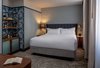 Modern home with Bedroom, Dresser, Carpet Floor, Bed, Table Lighting, Wall Lighting, and Night Stands. The standard King Room offers courtyard rooms and TRI-KES wallcovering. Photo 9 of The Eliza Jane