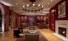 Modern home with Living Room, Medium Hardwood Floor, Coffee Tables, End Tables, Chair, Sofa, Recessed Lighting, Rug Floor, and Wall Lighting. The Press Room lounge is peppered with references to the building's ties to The Daily Picayune newspaper. The cranberry-colored room is anchored by a marble fireplace and a large custom brass light fixture. Photo 12 of The Eliza Jane