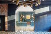 Modern home with Hallway and Porcelain Tile Floor. An elegant lobby welcomes guests with evergreen paneled walls and a geometric hex-tiled floor from Nemo Tile + Stone. Photo of The Eliza Jane