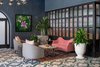 Modern home with Living Room, Coffee Tables, Chair, Sofa, Porcelain Tile Floor, End Tables, Rug Floor, and Pendant Lighting. A fluted glass partition separates an intimate lounge area adjacent the front lobby from the main public space. Photo 3 of The Eliza Jane