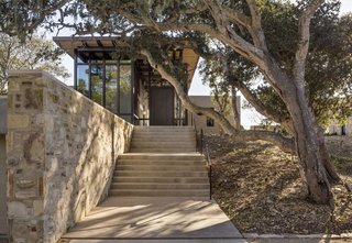 Stone walls, made with rock excavated on site, frame the ascent with cement steps.