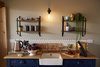 A white, hexagonal tile backsplash adds a modern touch to the upcycled 19th-century oak sideboard. Photo 14 of Ravendere Retreats modern home