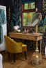 Modern home with Bedroom, Medium Hardwood Floor, and Chair. Guests can slip into the plush Emi Velvet Tub Chair while getting ready at the vanity, which is framed by a gorgeous Botanical Fleur Wallpaper Wall Mural. The large mirror is from Adame. Photo 7 of Ravendere Retreats