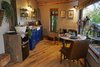 Modern home with Chair, Wall Lighting, and Medium Hardwood Floor. A look at the quaint kitchen and dining area. Complimentary staples are provided. Photo 13 of Ravendere Retreats