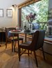 Modern home with Chair, Medium Hardwood Floor, and Wall Lighting. A pair of Peverall Upholstered dining chairs flank a McQueen dining table. Photo 15 of Ravendere Retreats