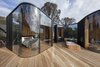 Modern home with Exterior, Prefab Building Type, Flat RoofLine, Glass Siding Material, Cabin Building Type, Metal Roof Material, and Wood Siding Material. All Coastal Pavilions are outfitted with a king-size bed. They also have a separate living area, including an outdoor bathtub, a bio-ethanol fireplace, as well as Wi-Fi and local treats. Photo of Freycinet Lodge