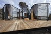Modern home with Exterior, Prefab Building Type, Metal Roof Material, Cabin Building Type, Flat RoofLine, Glass Siding Material, and Wood Siding Material. Meticulous detailing was required to create the curved forms. The deck is built of Grey Gumand and the roof is topped with Colorbond Trimdeck Sheeting in Night Sky Finish. Photo 12 of Freycinet Lodge