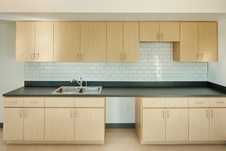 The kitchen features a Trinity Tile backsplash as well as Formica plastic laminate counters and cabinets.