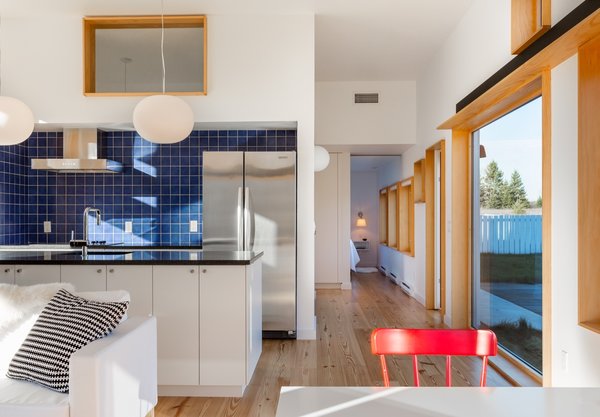 The Open Kitchen Is Fitted With Black Granite Counters A Ceramic Backsplash And Melamine The Open Kitchen Is Fitted With Black Granite Counters A Ceramic Backsplash And Melamine