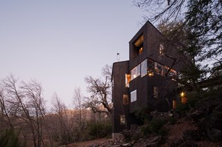 The timber-clad cabin is in the shape of a 'V' to optimize views of the Valle Las Trancas below.