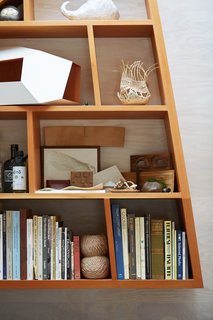 The custom Douglas Fir bookshelf echoes the angles of the office.